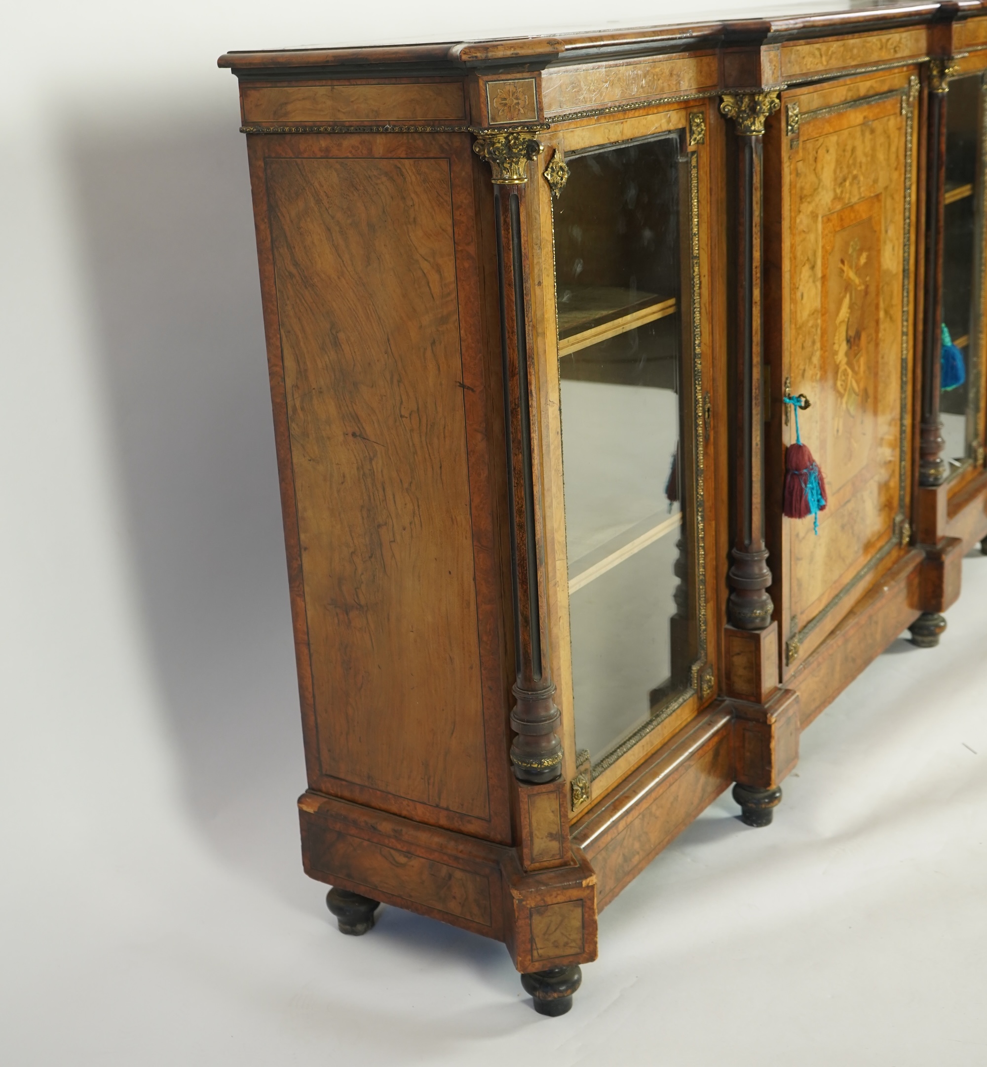 A Victorian birds eye maple banded, gilt metal mounted figured walnut side cabinet